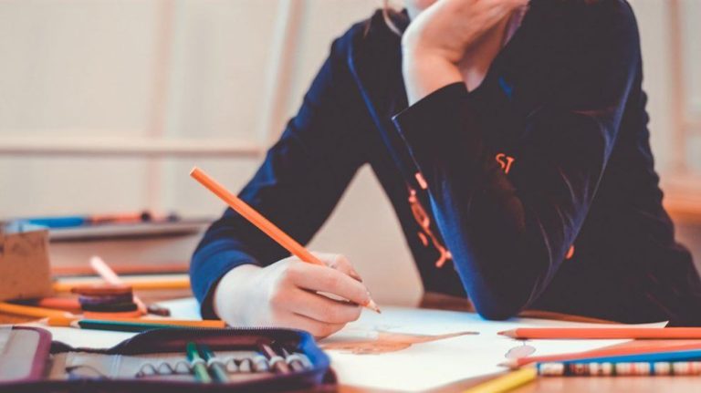 student writing at desk