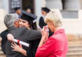 Parents hugging new graduate