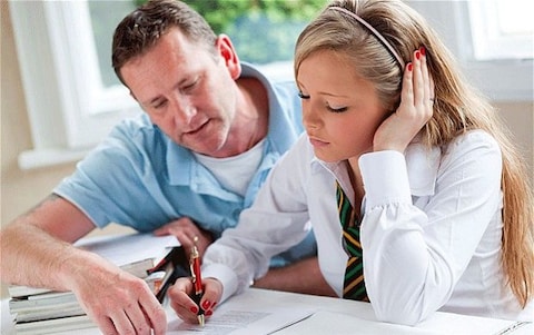 dad helping teen daughter with work