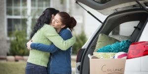 Mother hugging college student at dropoff