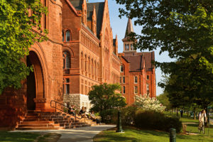 red brick college buildings with blue sky