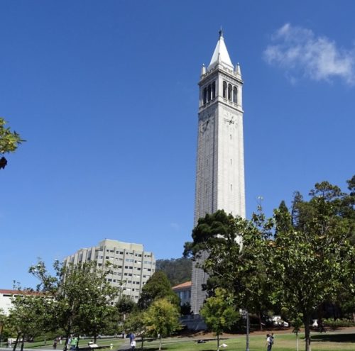 clock tower against blue sky on college campus