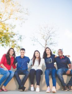 students sitting together on a wall