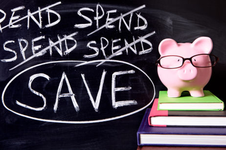 Piggy bank on books in front of chalkboard