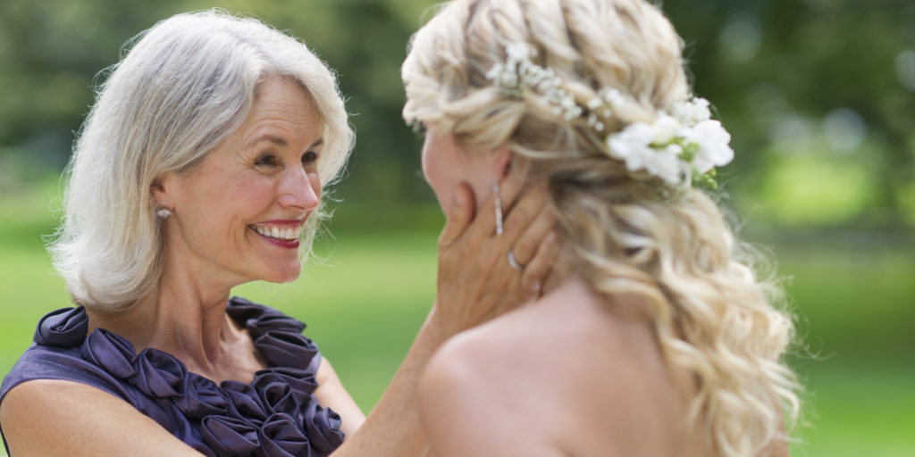 Mom looking at daughter on her wedding day