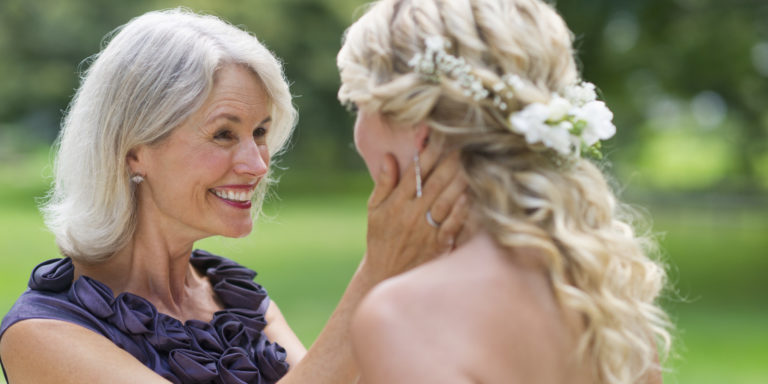 Mom looking at daughter on daughters wedding day