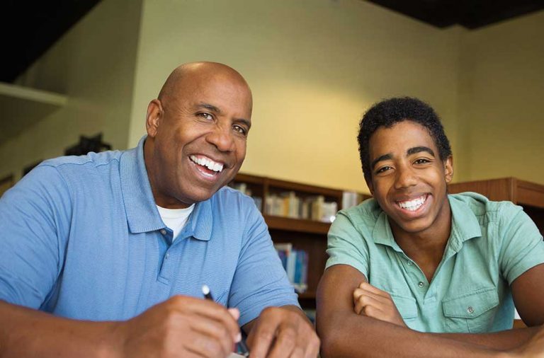 male teen with counselor in library