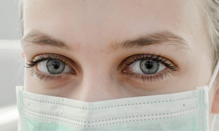 close up of woman wearing hospital mask