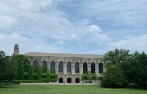 college building with lawn in front and blue sky in background