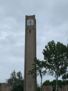 Rectangular clock tower with cloudy background